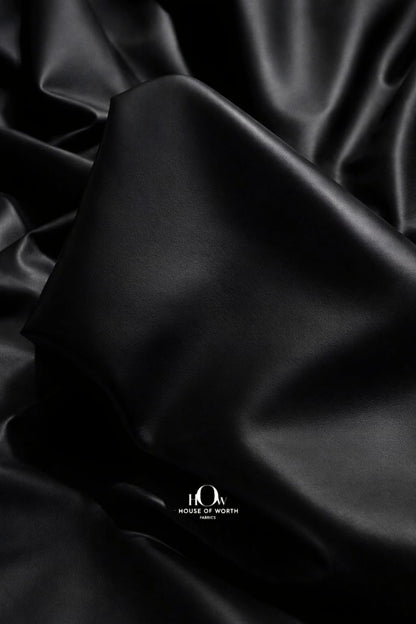 Black imported leather fabric close-up with smooth rich finish for luxury jackets