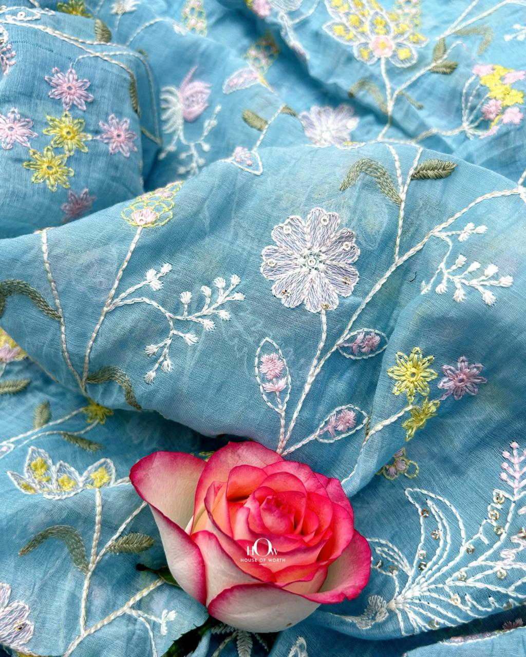 Serene blue Chanderi fabric with floral embroidery, lightweight and sheer for ethnic wear.
