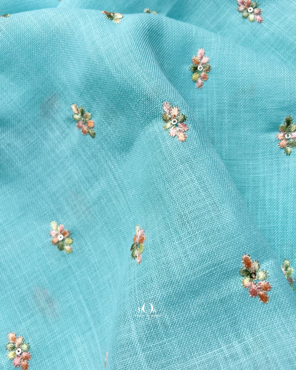aqua blue floral embroidered linen fabric ideal for high-end ethnic garments.