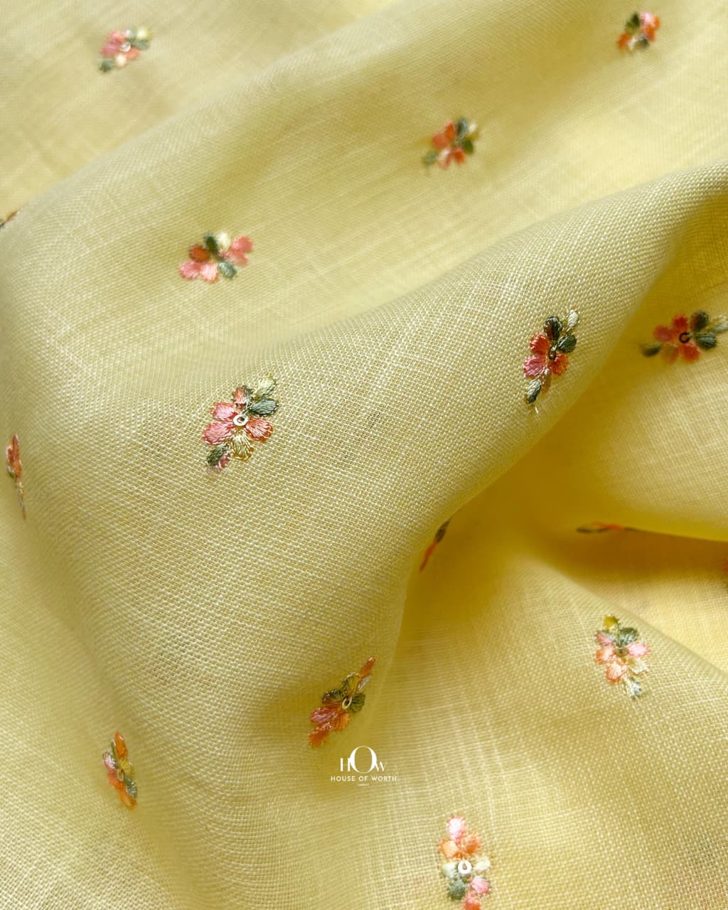 Vibrant yellow linen embroidery fabric, lightweight and structured, ideal for designer kurtas and dresses.