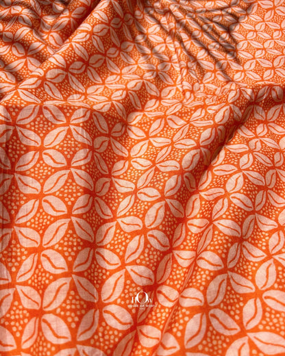 Bold orange Malai Chanderi fabric with all-over print – perfect for kurtis, salwar sets, and festive dresses.