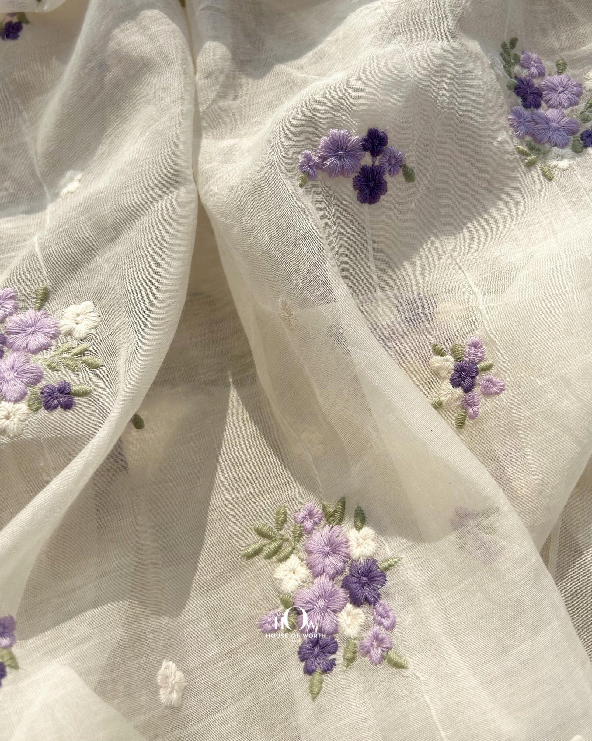 Wholesale supplier of dyeable Pure Chanderi fabric – off-white base with thread embroidered purple buttas, available in Delhi and Surat.