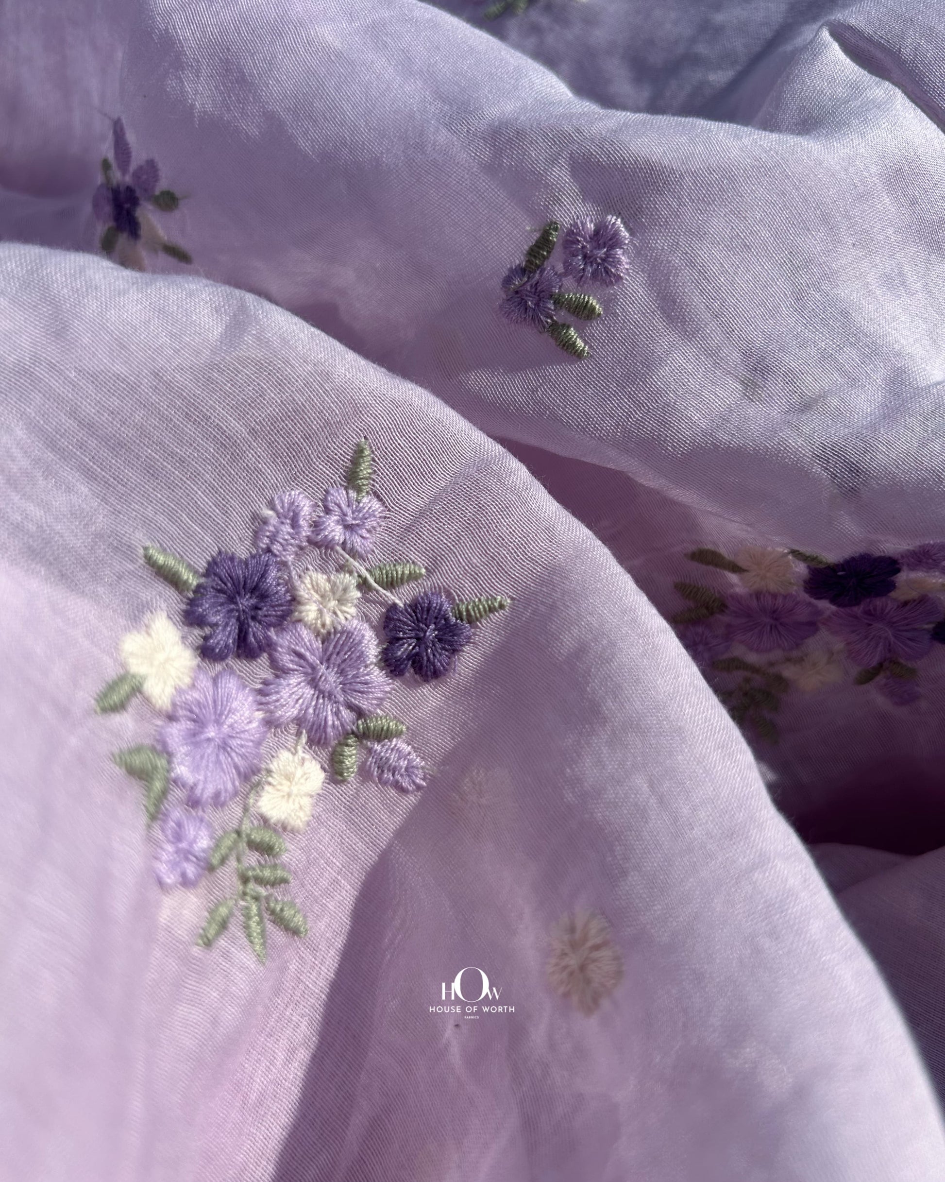 Pastel lavender Chanderi fabric with small floral motifs – perfect for boutique designers and custom tailoring.