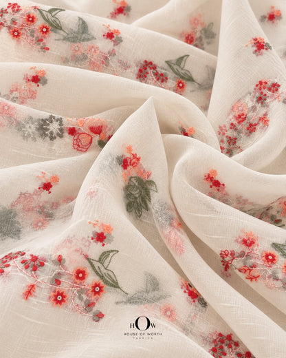 Close-up of coral red and peach floral vine embroidery with muted green leaves on ivory Mul Chanderi