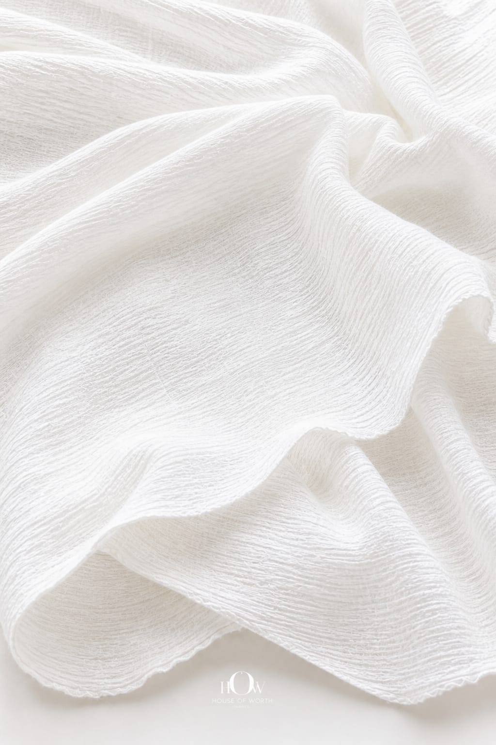 Crinkled cotton fabric draped elegantly—lightweight, breathable 100% cotton material for dresses