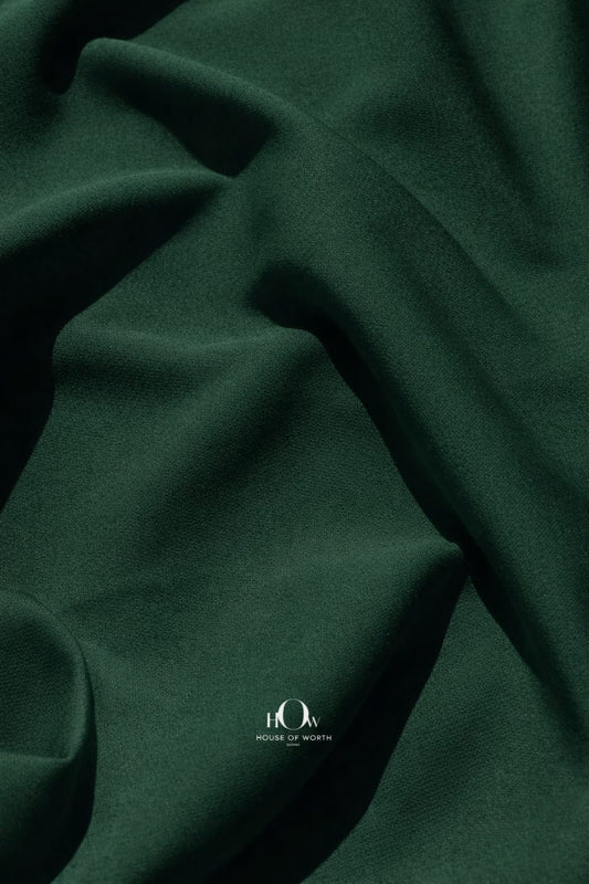 Dark bottle green imported banana crepe fabric, smooth finish for gowns and party wear