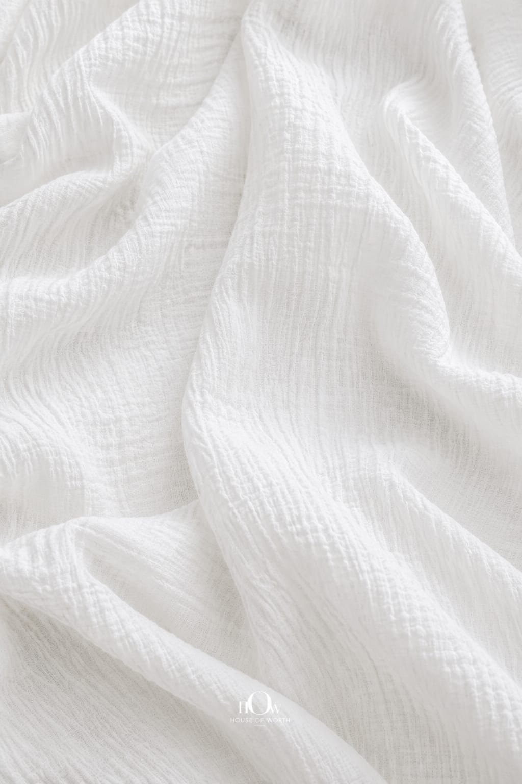Pure crinkle cotton fabric highlighting its natural textured weave; dyeable soft cotton cloth