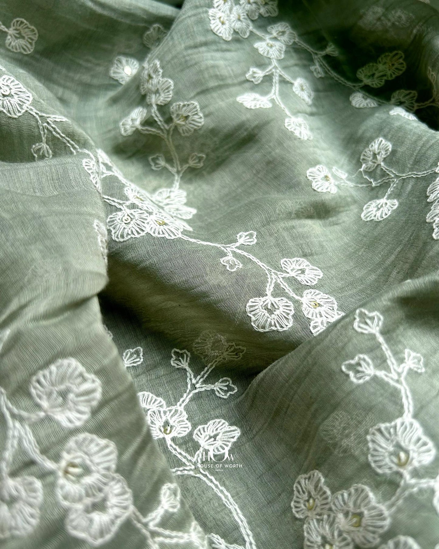 Pure Mul Chanderi fabric with white floral embroidery – pastel green material for kurtis, sarees, and dress sets.