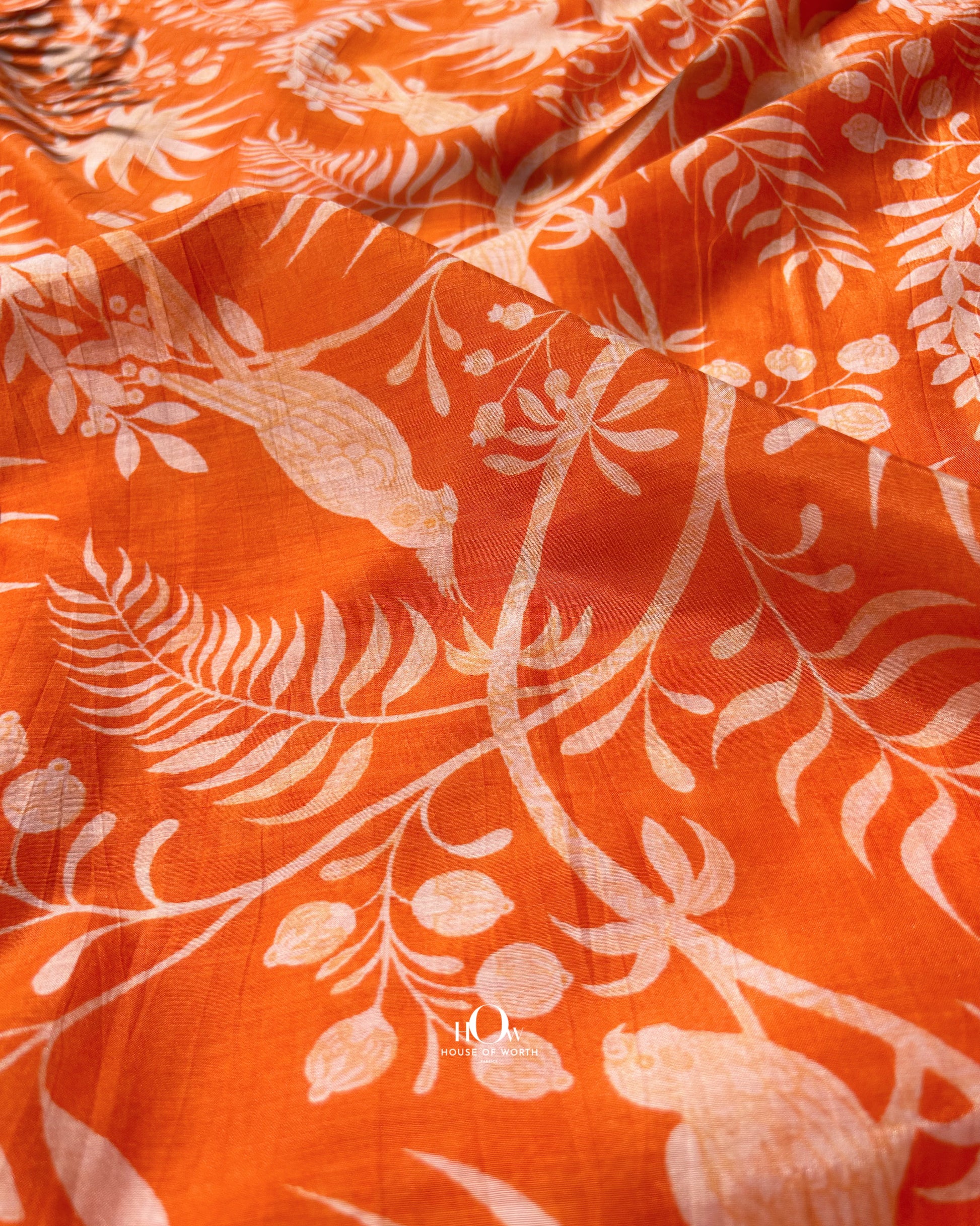 Bright orange Malai Chanderi fabric with nature pattern – soft and breathable material for summer suits.