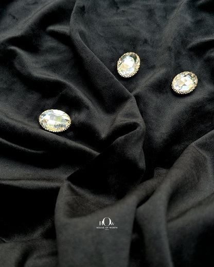 Smooth black velvet fabric draped in soft folds
