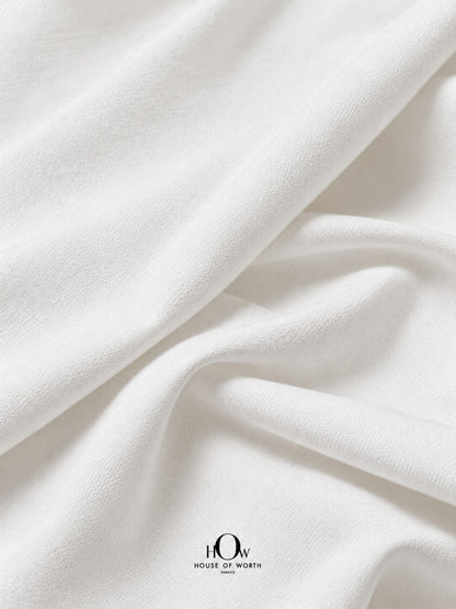 Imported white denim fabric showing a fine textured surface and solid dyeable base