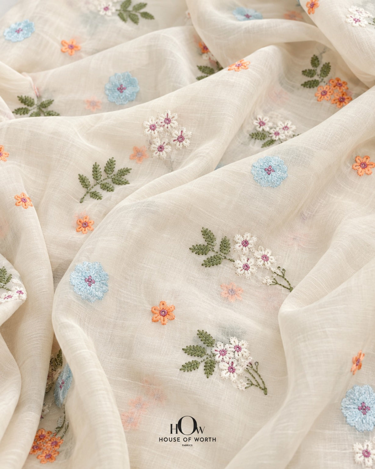 Ivory white Pure Mul Chanderi with scattered blue, peach and green all-over floral embroidery