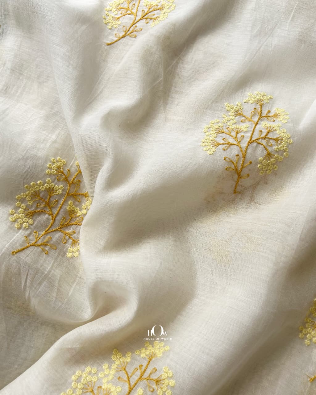 Pure Mul Chanderi with spaced yellow floral buti motifs on a soft ivory base
