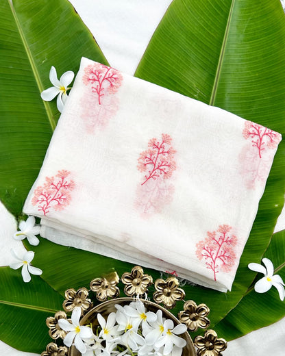 Coral pink floral sprigs with red stems on ivory Kasavu Pure Mul Chanderi fabric