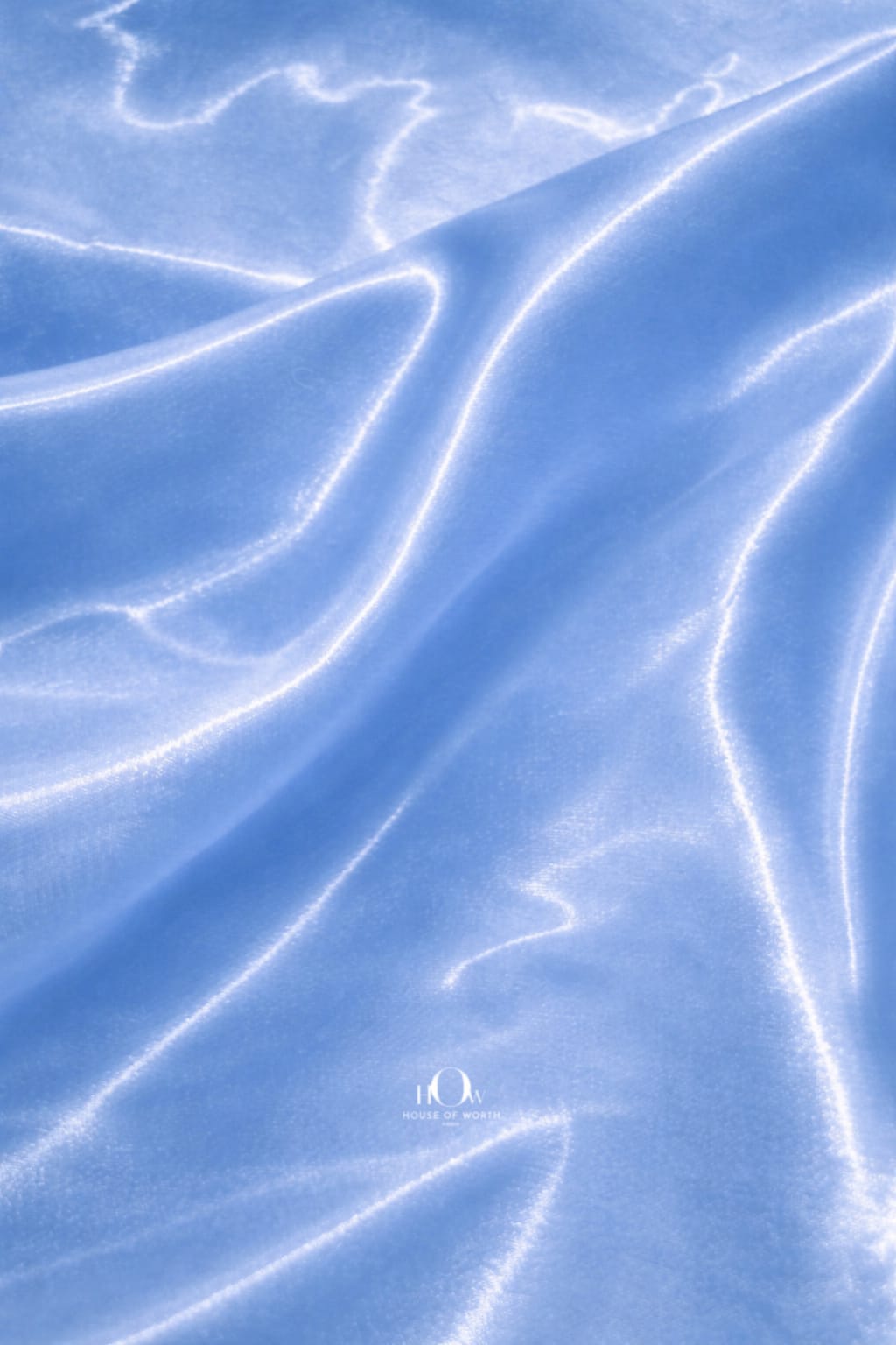 Premium glass satin fabric in soft blue shade for designer wear
