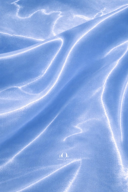 Premium glass satin fabric in soft blue shade for designer wear