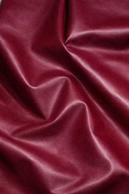 Maroon imported leather fabric close-up with wine-rich sheen for premium jackets and co-ords