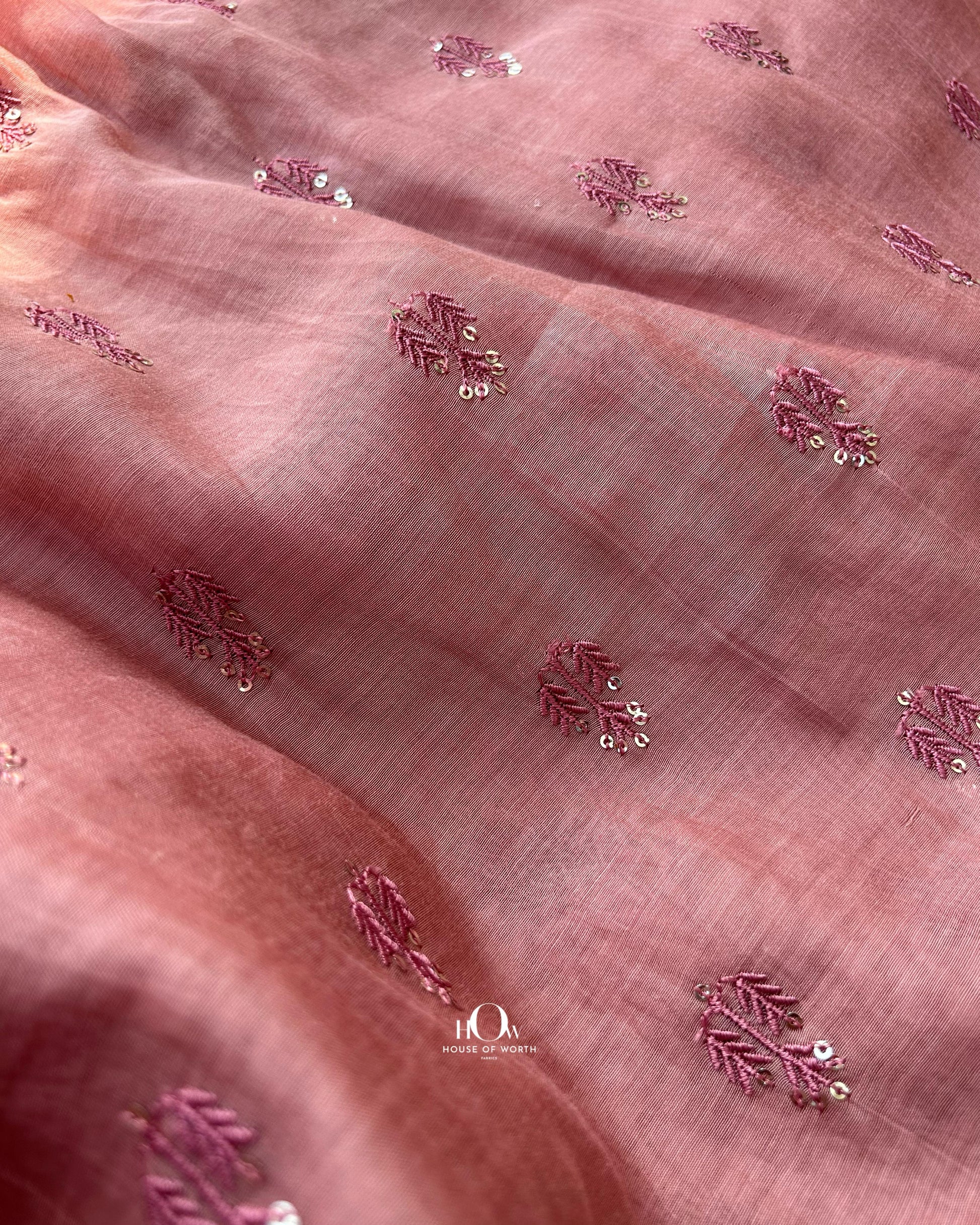 Rust peach Mul Chanderi fabric with subtle butti design – lightweight, breathable, and sourced from top fabric suppliers in Surat and Banaras.