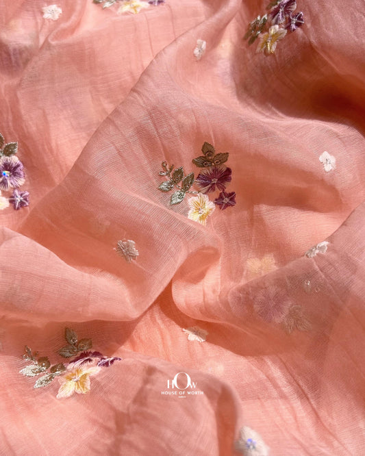 Peach Pure Mul Chanderi fabric with multicolor floral embroidery – perfect for sarees, suits, and ethnic collections.