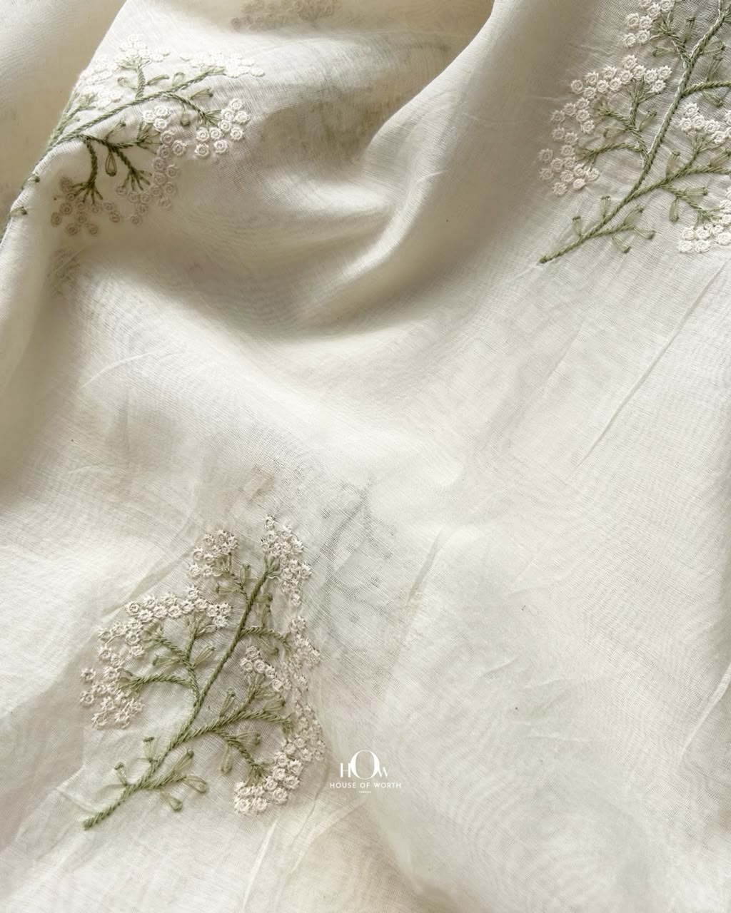 Draped ivory Pure Mul Chanderi fabric with spaced floral buti motifs and soft folds