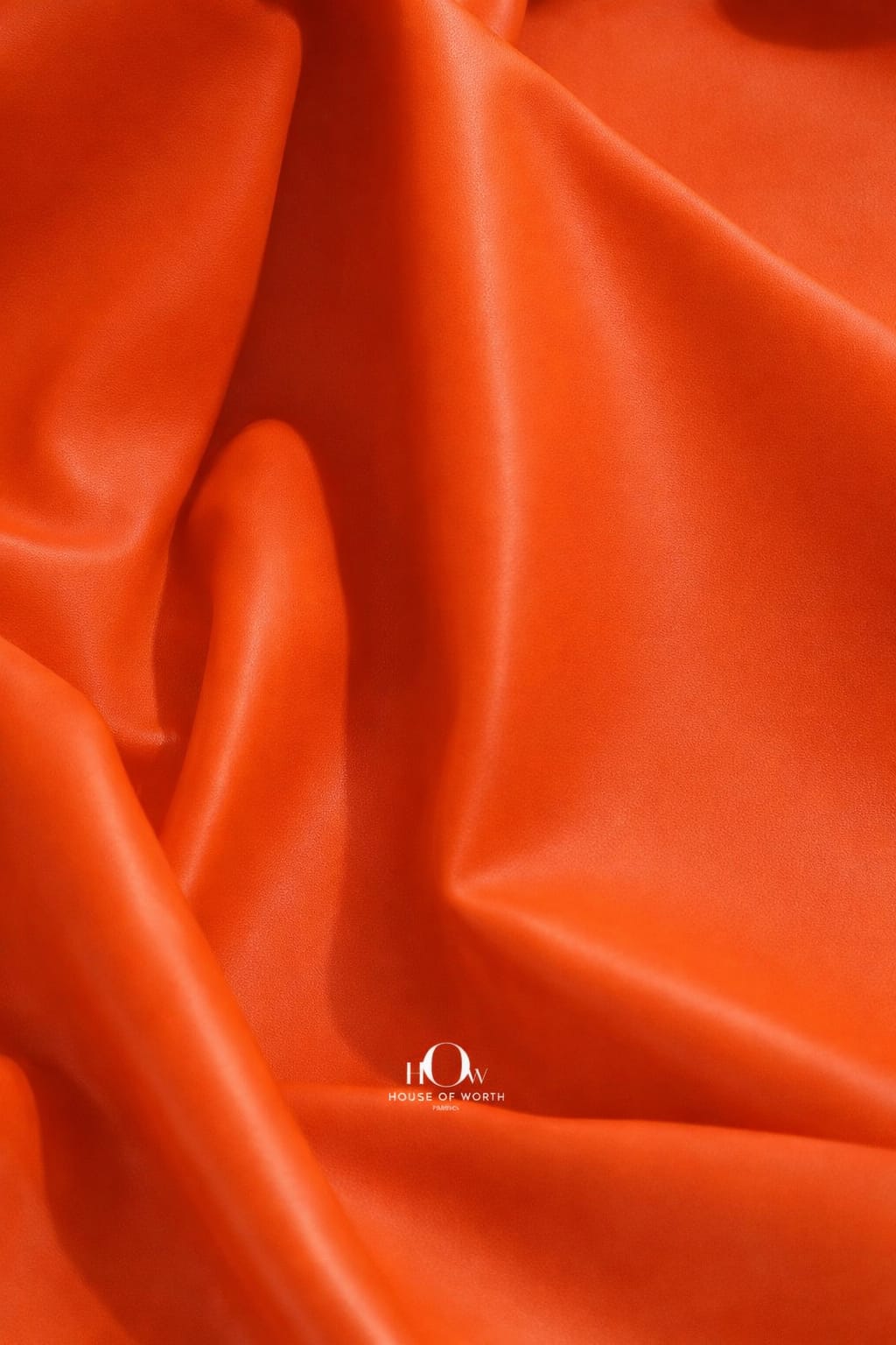 Orange imported leather fabric texture with vibrant sheen for statement jackets and pants