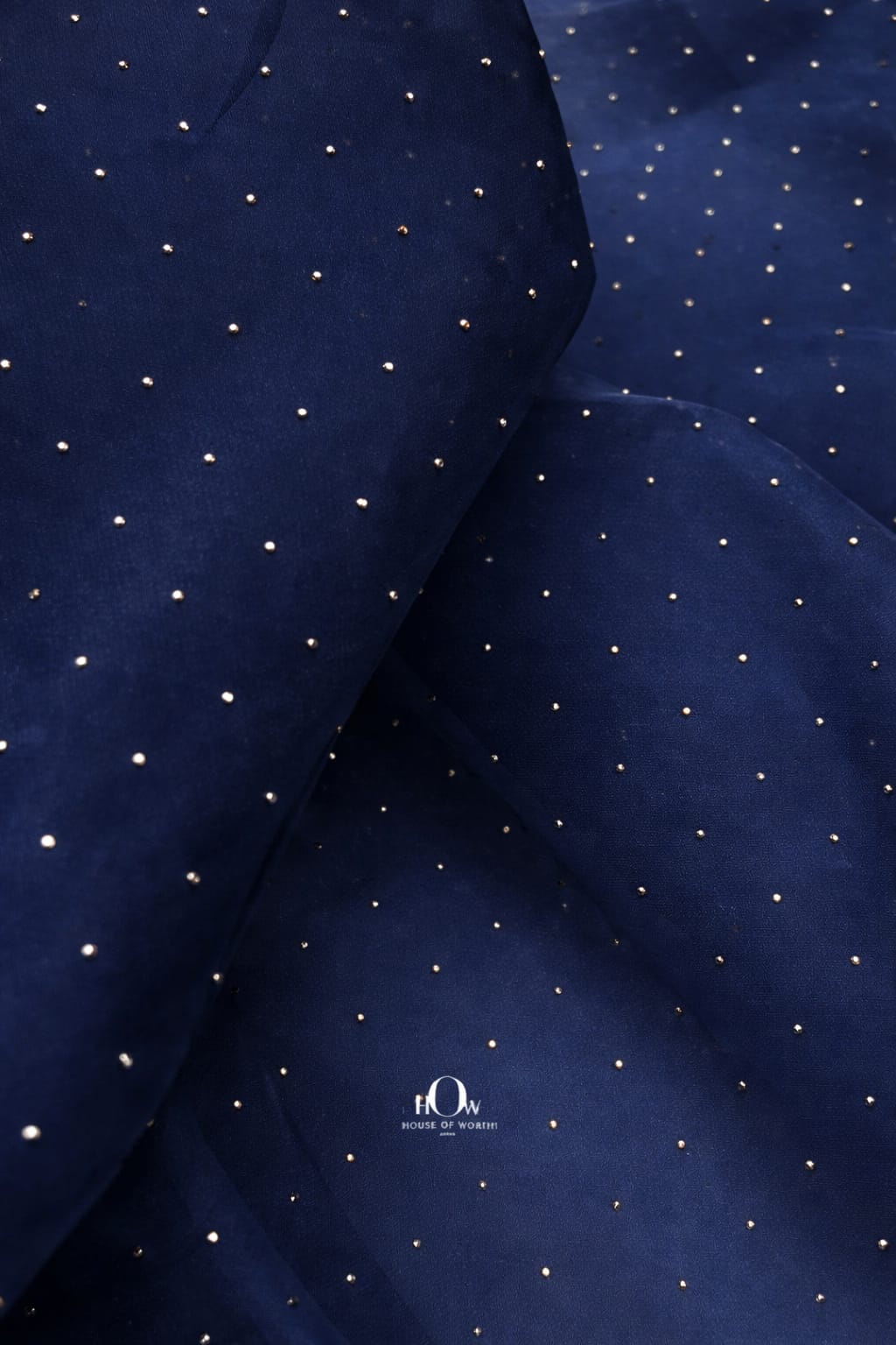 Navy blue organza fabric with rhinestone embellishments for rich, sophisticated designs