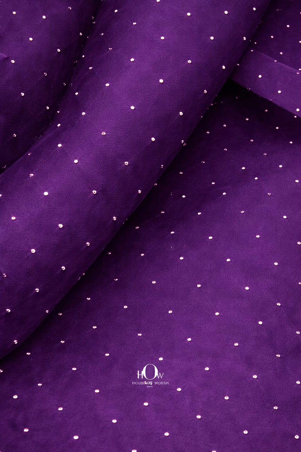 Purple organza fabric with embedded rhinestones for a regal and elegant touch