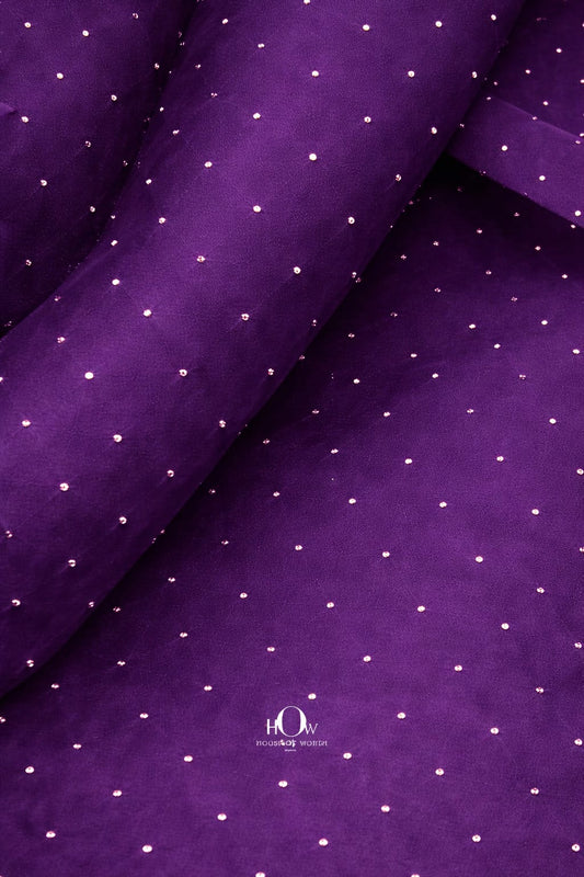Purple organza fabric with embedded rhinestones for a regal and elegant touch