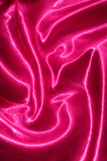 Premium glass satin fabric in vibrant pink shade for couture wear
