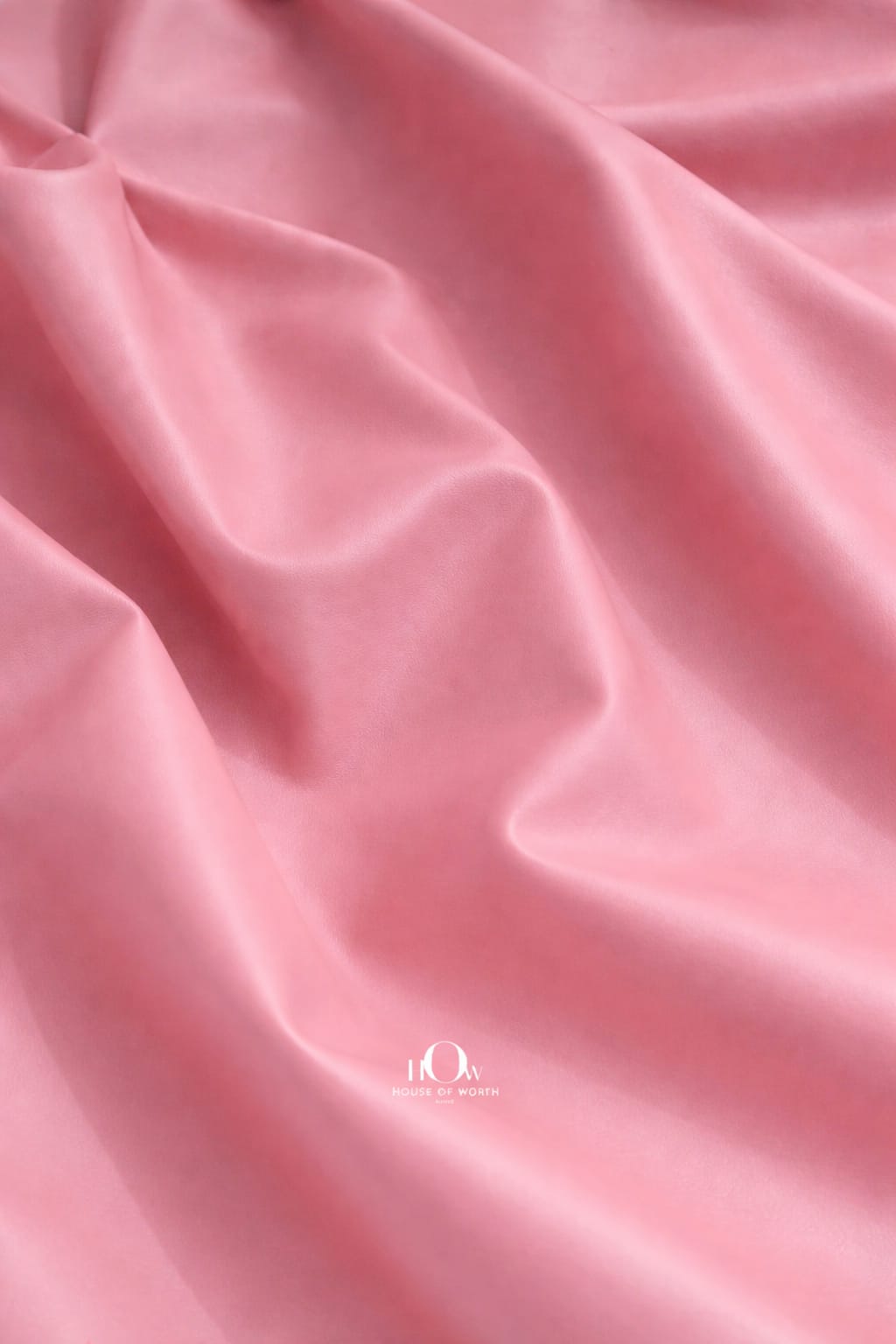  Pink imported leather fabric close-up with polished finish for couture jackets and co-ords