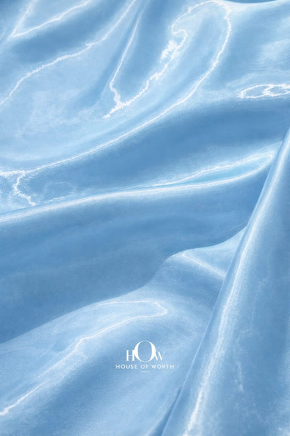 Heavy satin fabric with smooth texture and luminous blue sheen