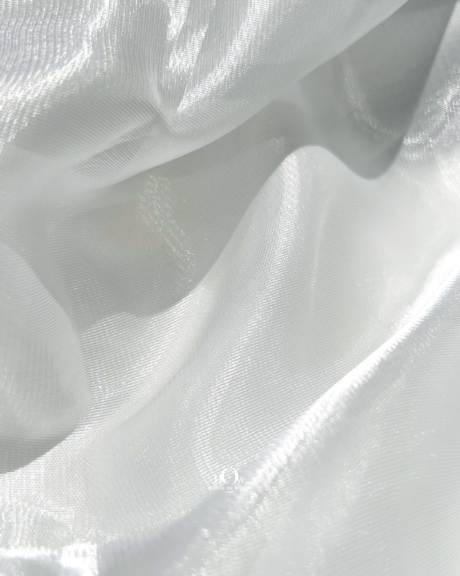 Luxurious glass organza dupatta for bridal lehengas, shining under showroom lights in Surat.