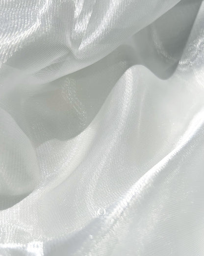 Luxurious glass organza dupatta for bridal lehengas, shining under showroom lights in Surat.