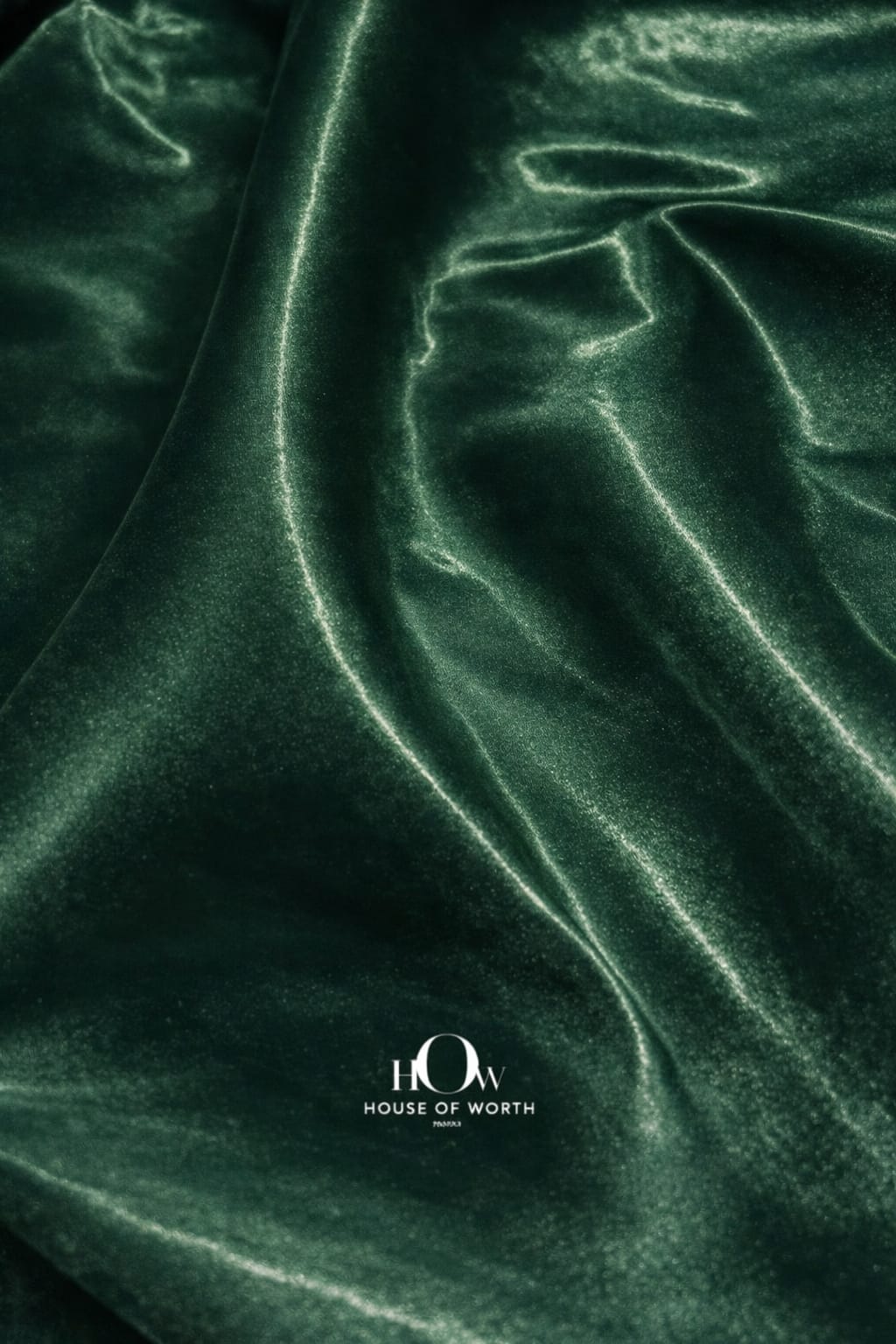 Heavy satin fabric with smooth texture and rich green sheen