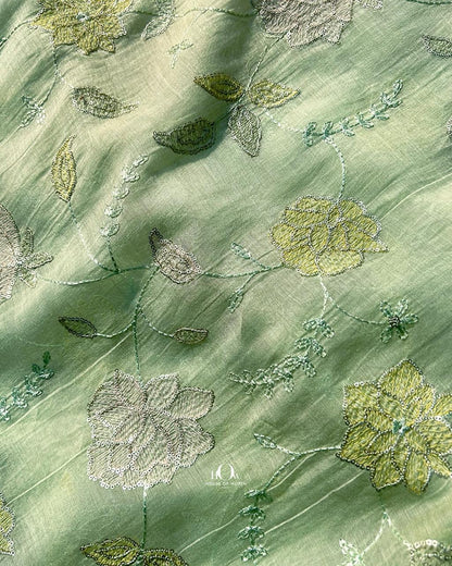 Elegant mul chanderi fabric with soft sheen and floral embroidery