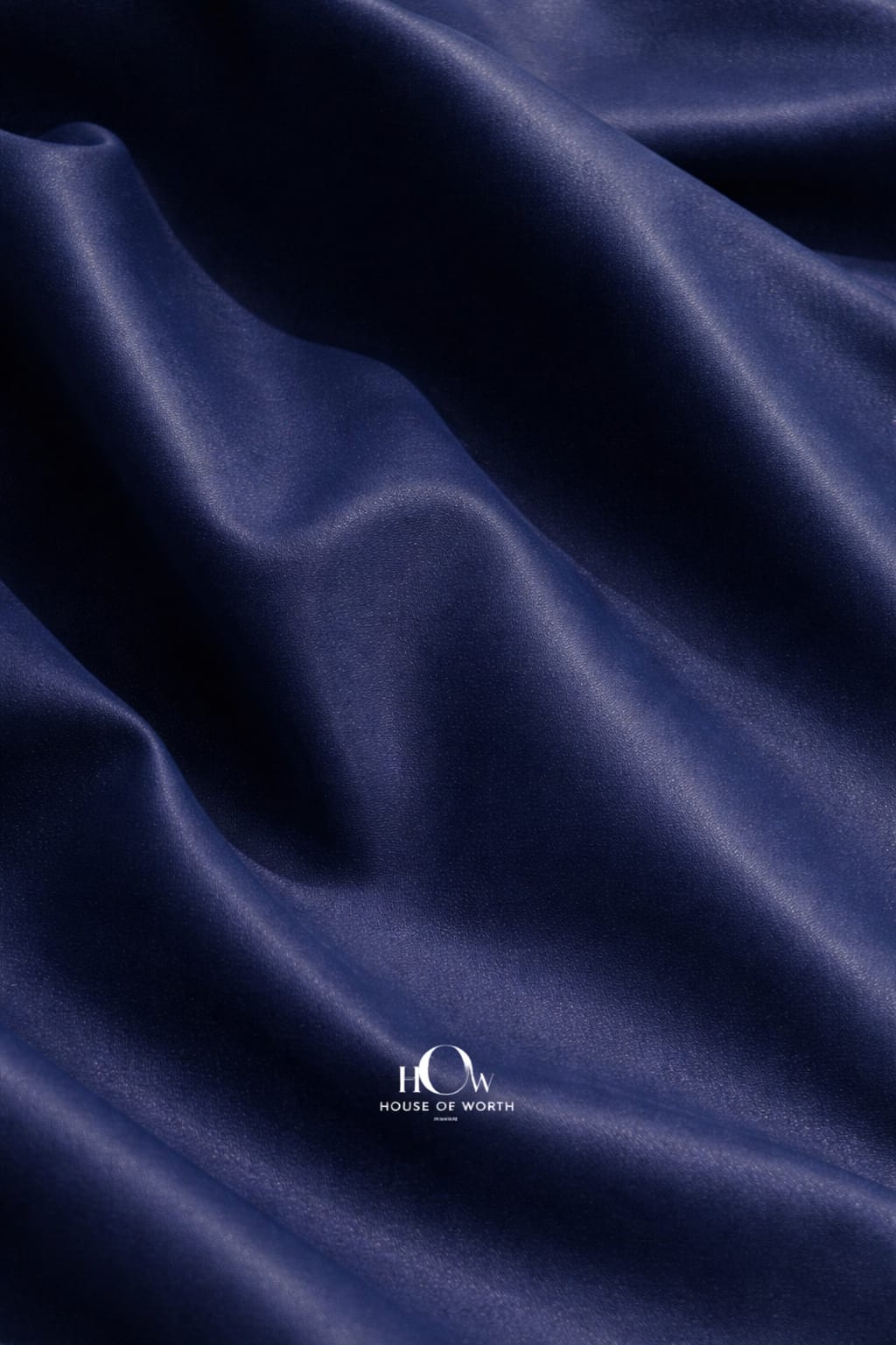 Premium navy blue leather fabric drape for jackets—soft yet structured, designer-ready