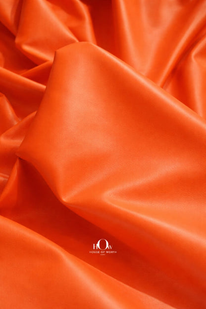 Premium orange leather fabric drape—soft yet firm for tailoring and designer sampling