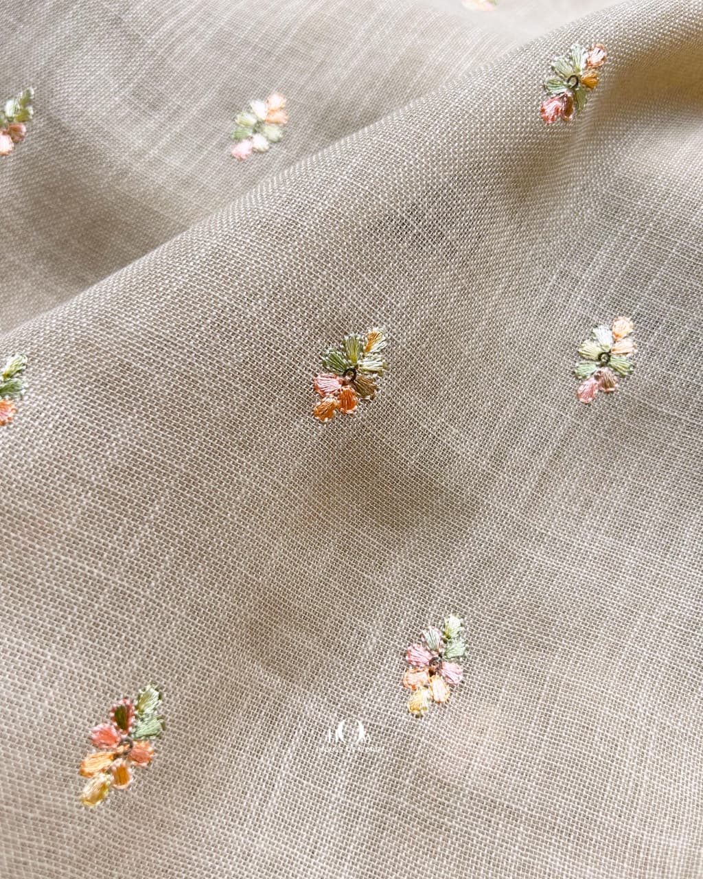 Lightweight taupe cotton-linen blend fabric embroidered with florals, ideal for designer outfits.