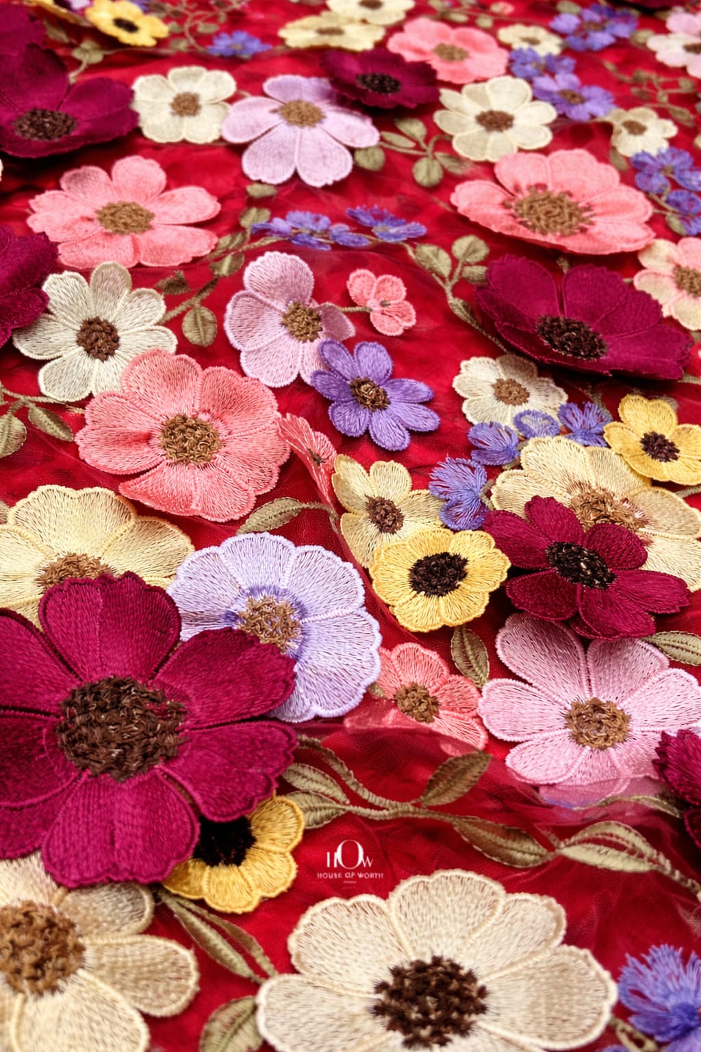 Red floral applique fabric with dramatic raised florals on net, luxe choice for bridal wear