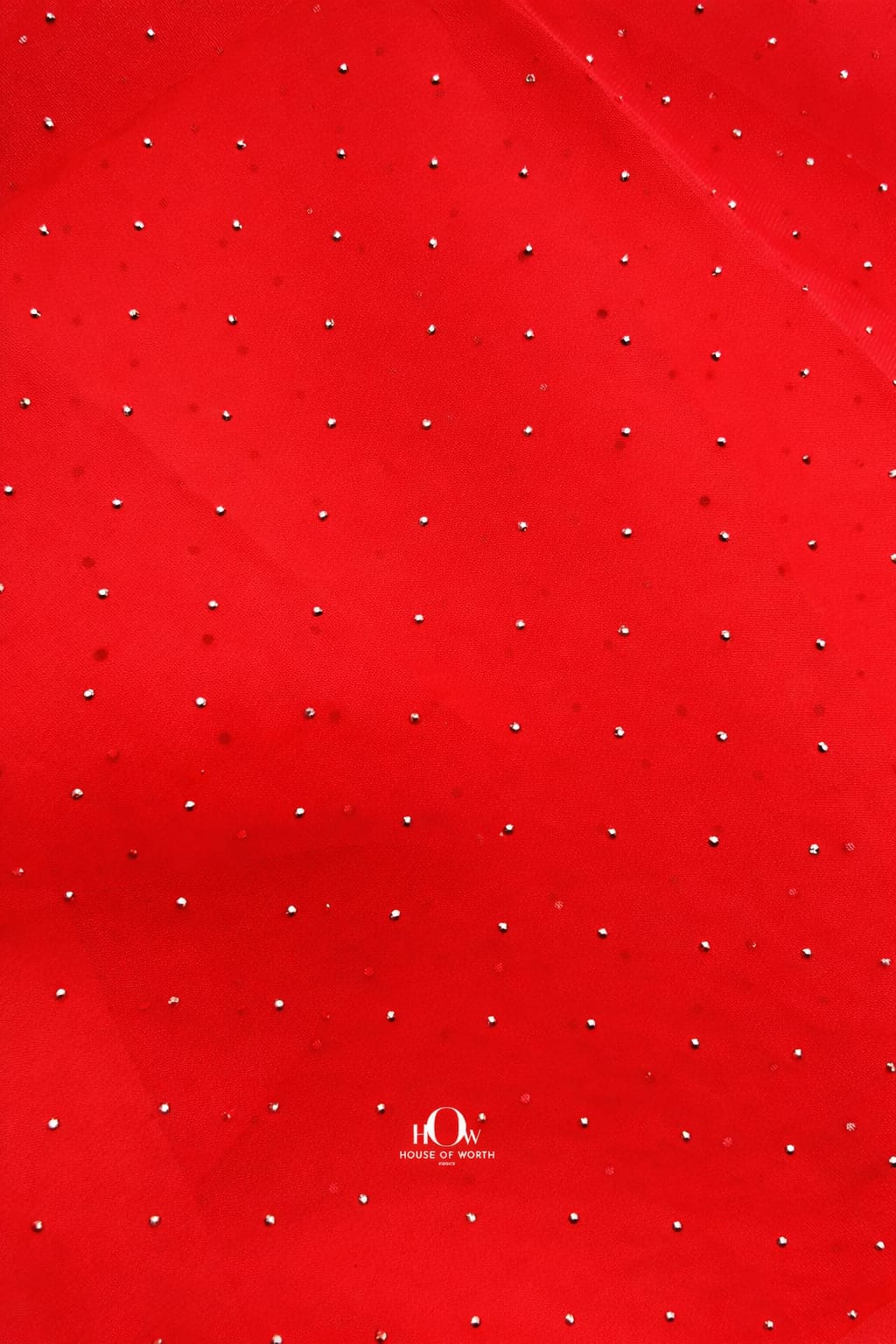 Elegant red organza material adorned with sparkling crystals