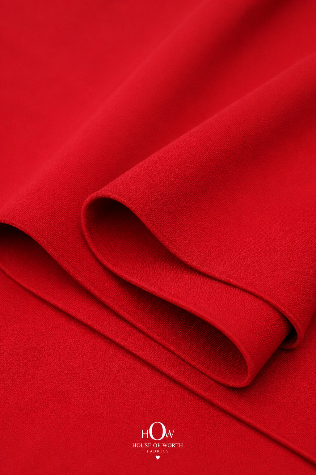 Red Imported Scuba Sandwich Fabric draped to show its structured body and strong solid colour
