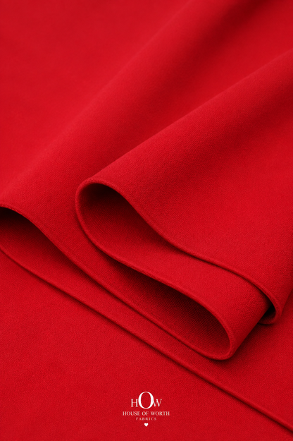 Red Imported Scuba Sandwich Fabric draped to show its structured body and strong solid colour