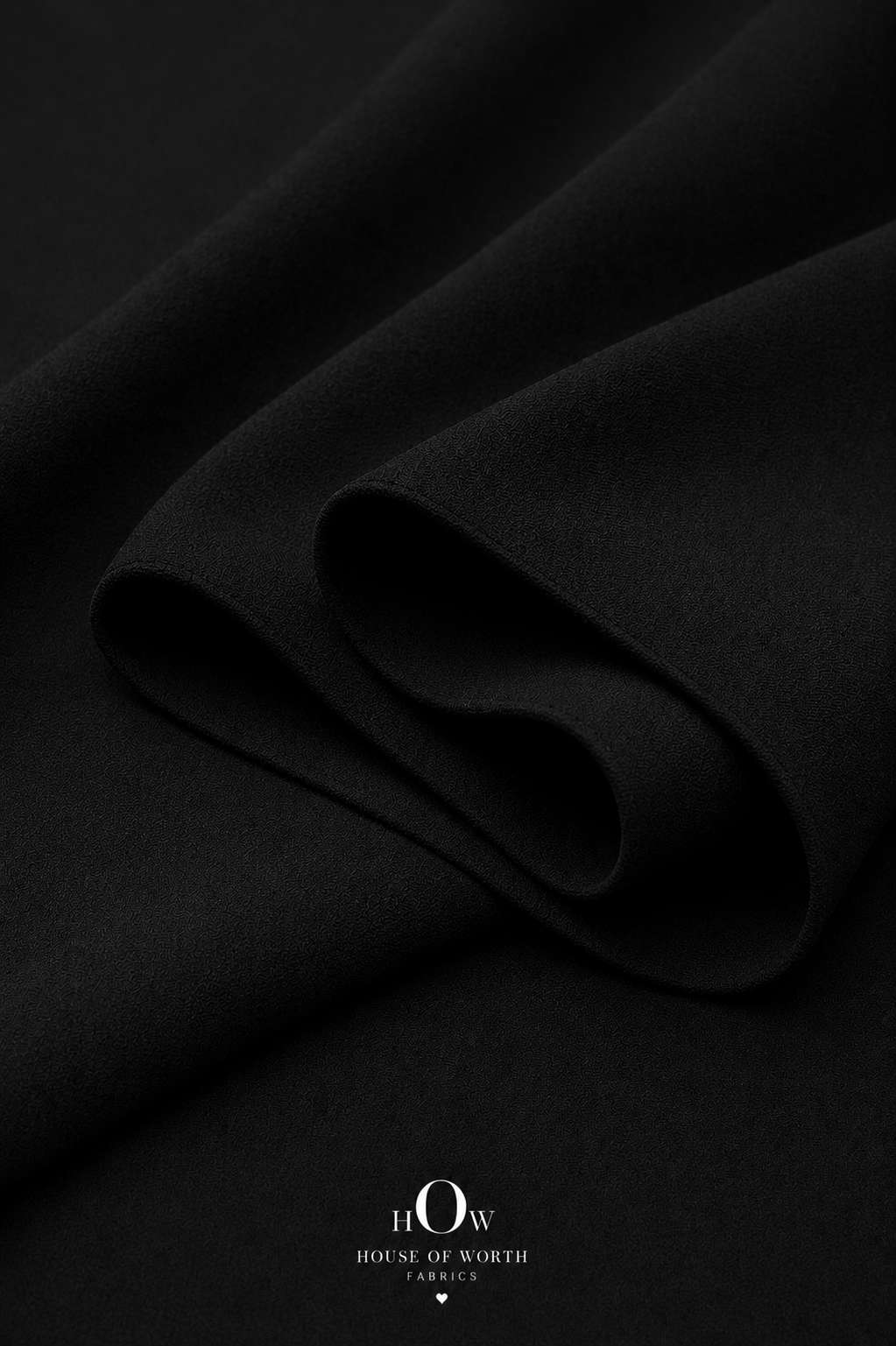 Black Imported Scuba Sandwich Fabric draped to show its structured body and deep solid colour