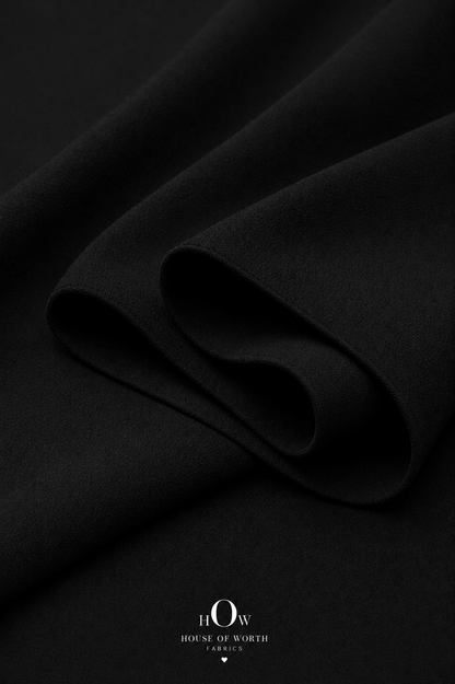 Black Imported Scuba Sandwich Fabric draped to show its structured body and deep solid colour