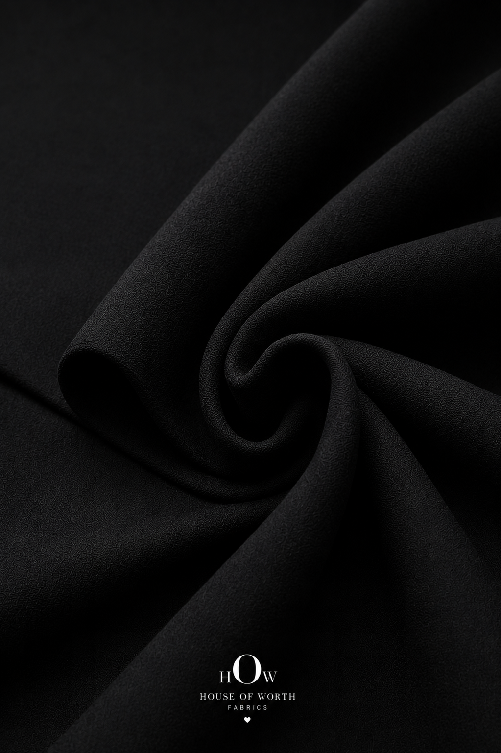 Close-up of black Scuba Sandwich Fabric showing its smooth-looking surface and neat solid finish