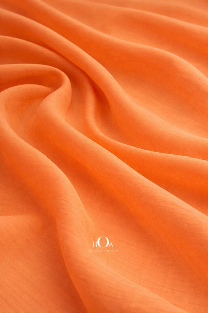 Orange cotton poplin fabric with crisp structured drape