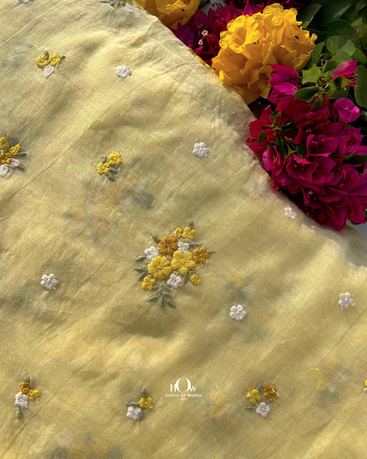 Pure Mul Chanderi fabric with small floral buttas – soft yellow fabric ideal for sarees, suits, and festive garments.