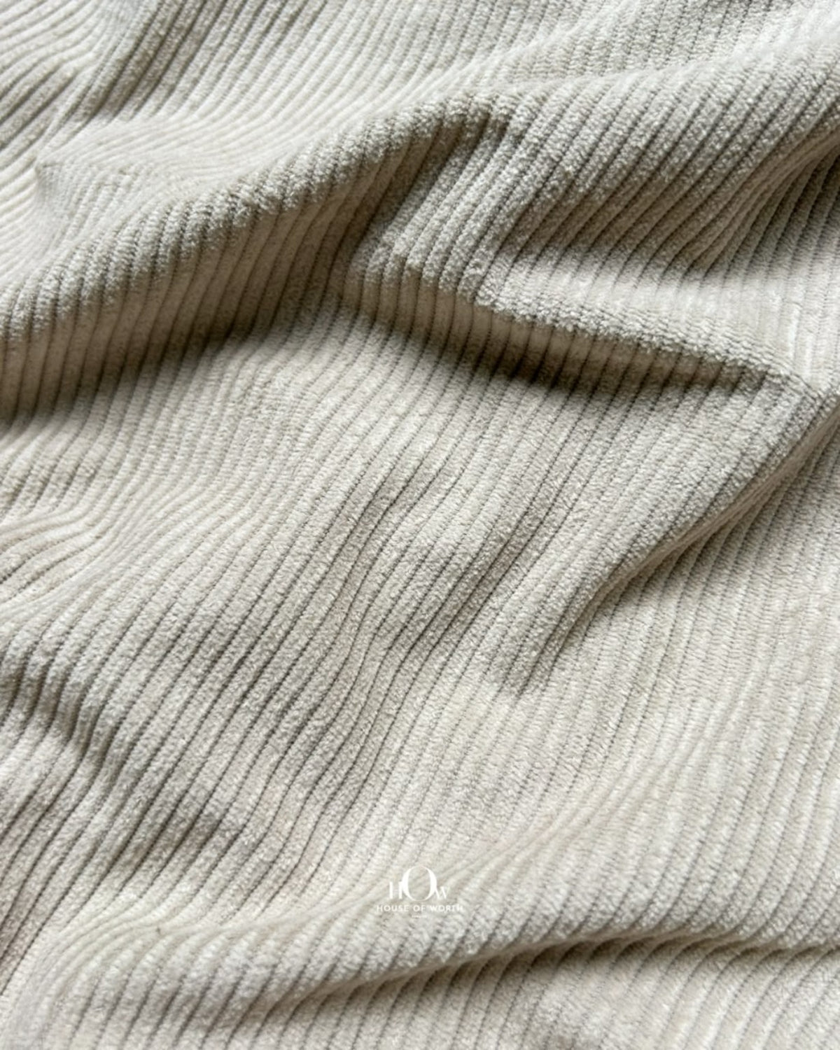 Solid beige corduroy fabric with visible ribbed lines for jackets, shirts and trousers