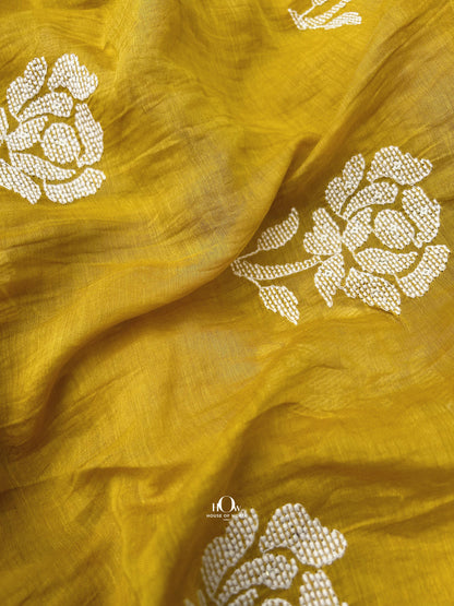 Pure embroidered Mul Chanderi fabric in yellow – bold white floral motifs ideal for boutique tailoring and festive wear.