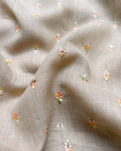 Neutral taupe linen embroidery fabric with subtle floral motifs, perfect for kurta and dressmaking.